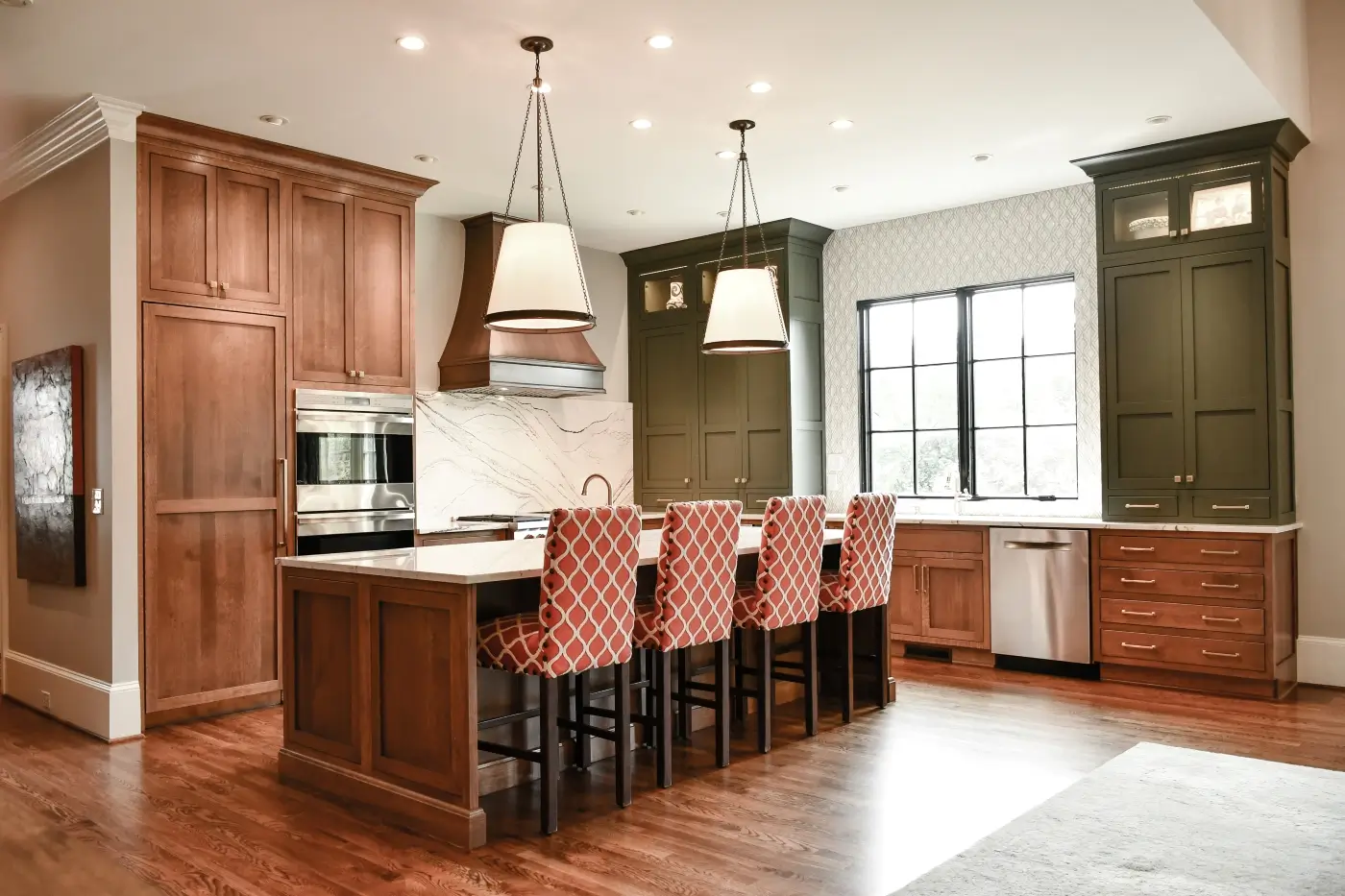 Custom kitchen with cherry and olive-green cabinetry, marble backsplash and a large island