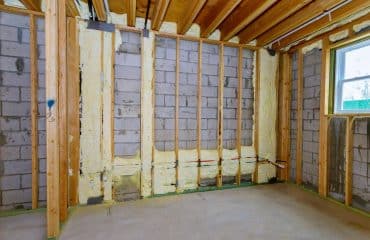 New wooden house in foam for insulation the wall of a basement unfinished under construction
